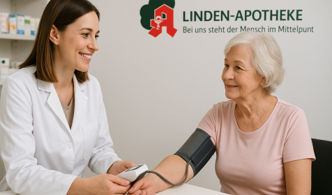 Apothekerin misst mit einem digitalen Blutdruckmessgerät den Blutdruck einer Seniorin in einem Apotheken-Beratungsraum. KI‑generiert